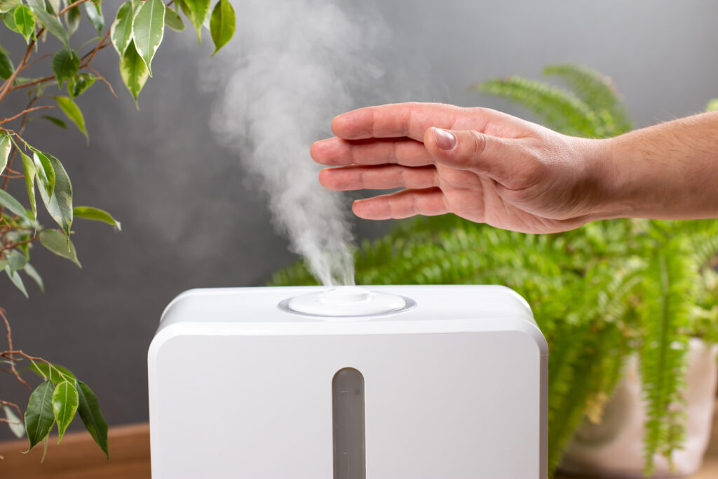 man holds hand steam aroma oil diffuser home x