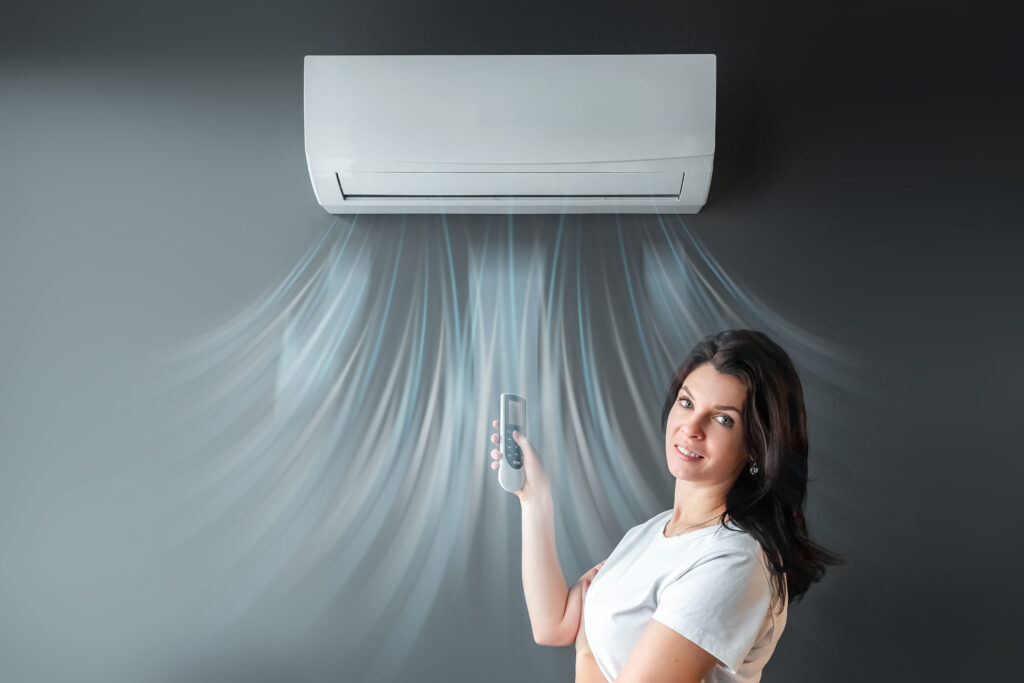 beautiful girl stands air conditioning stream fresh cold air against gray wall concept heat cool air cooling freshness x