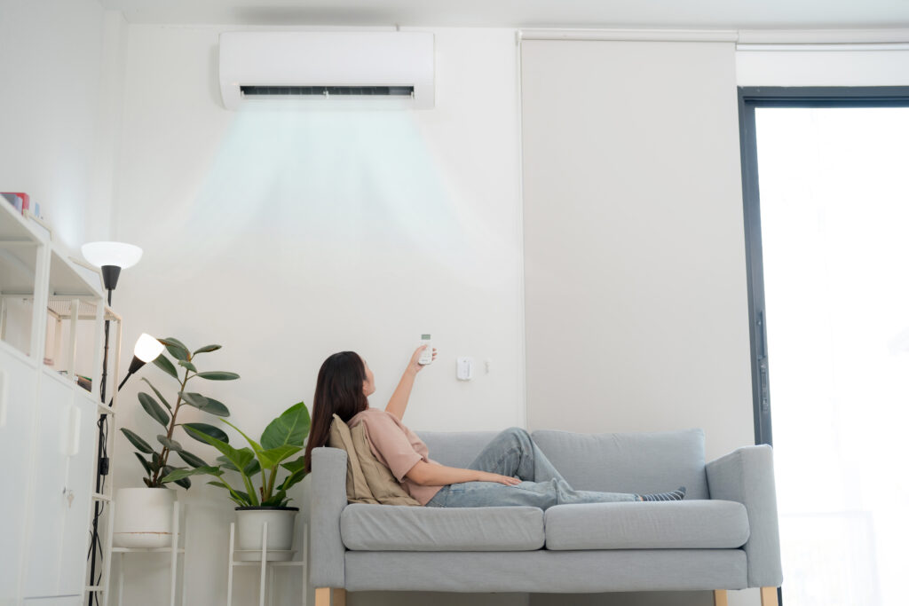 young woman enjoying air conditioning home x