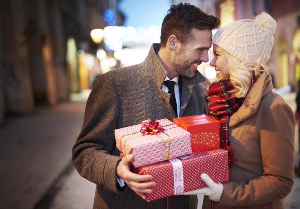 affectionate couple with stack presents x