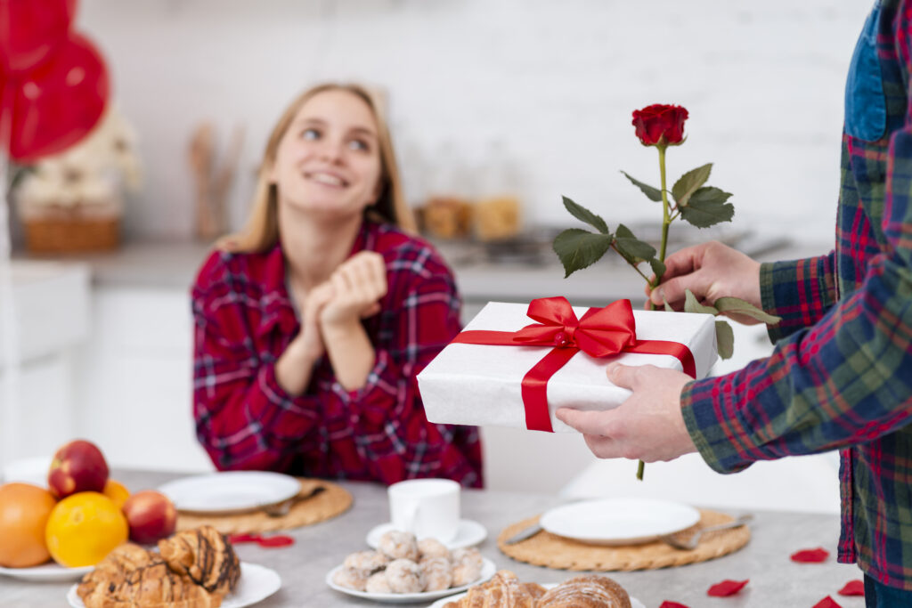 close up man surprising woman with rose gift x